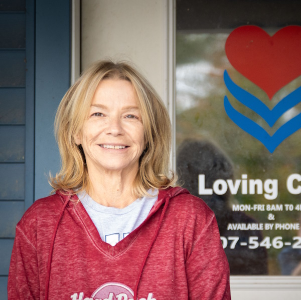 headshot photo of Marie Vandegrift in front of the Loving Care office door